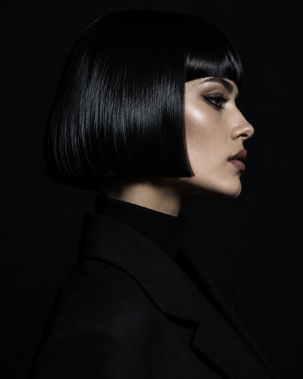 Glossy jet-black precision bob in profile